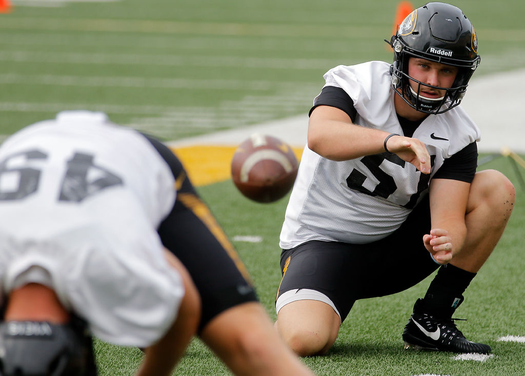 Drew Wise receives a practice snap from long snapper Jake Hoffman